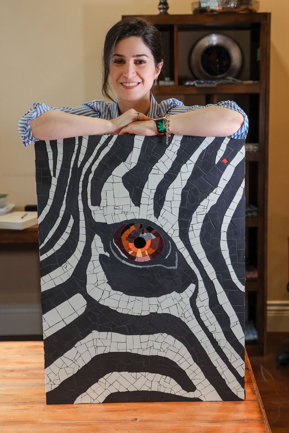 Artist displays striking black and white zebra-inspired mosaic artwork featuring an orange eye detail.