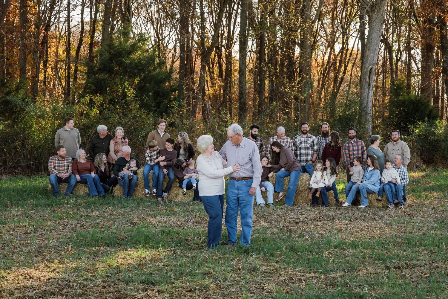Large group gathered outdoors at a scenic lakeside venue.
