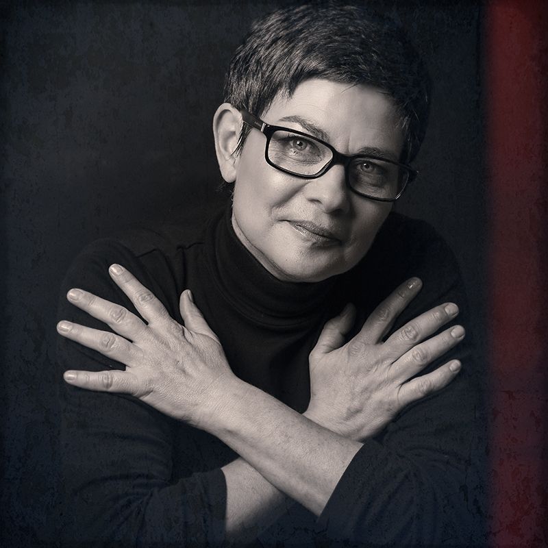 A sequence of dramatic black and white portraits showing hands covering face in different positions against dark background.
