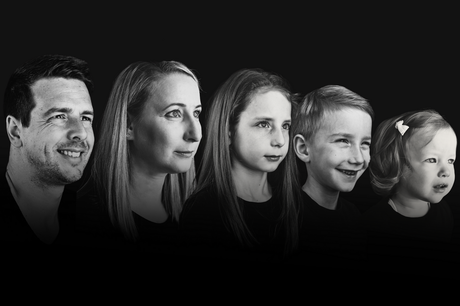 Dramatic black and white side profile portrait of five family members in a row.