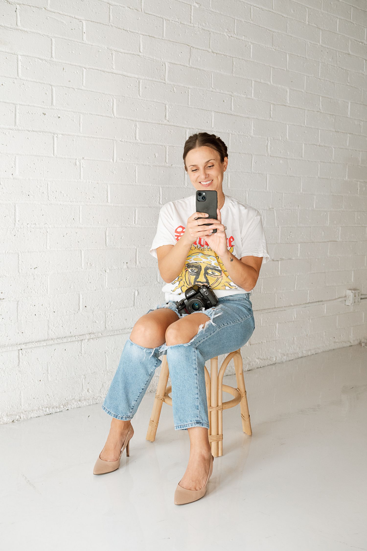 Lifestyle photography showing relaxed poses with mobile phone against white studio backdrop.