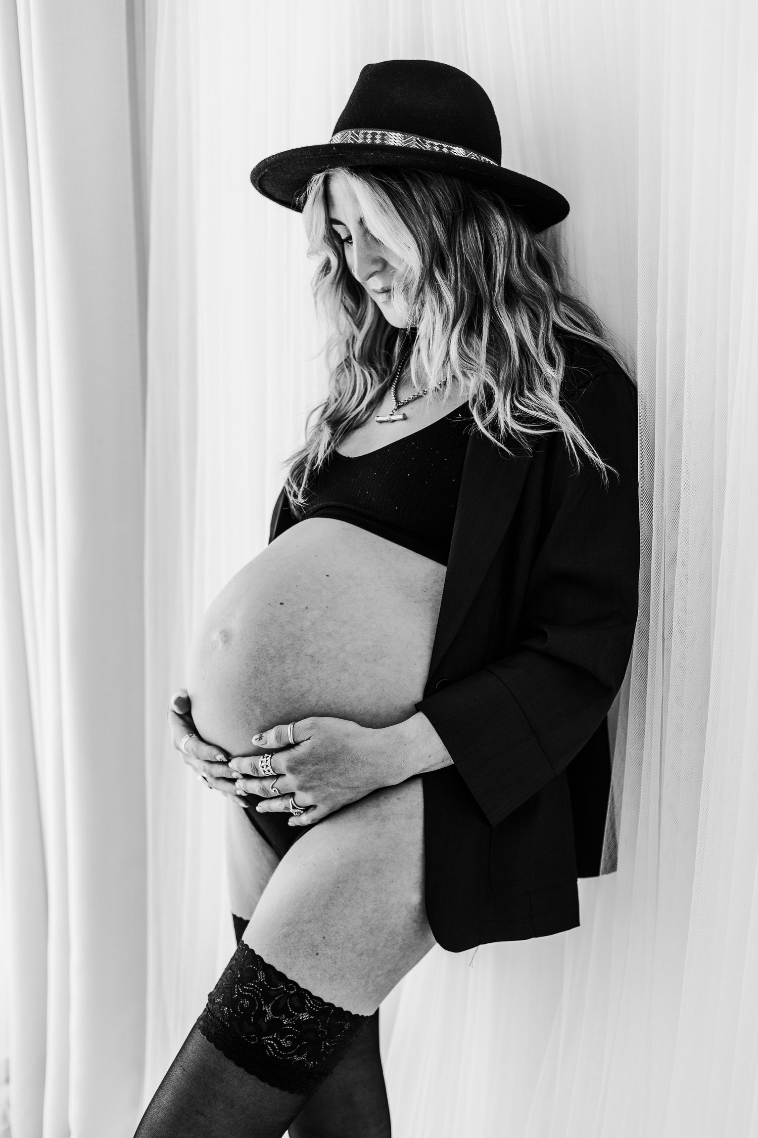 Expectant mum photographed in Nottingham studio maternity session, elegant and timeless pregnancy portraits in neutral styling.