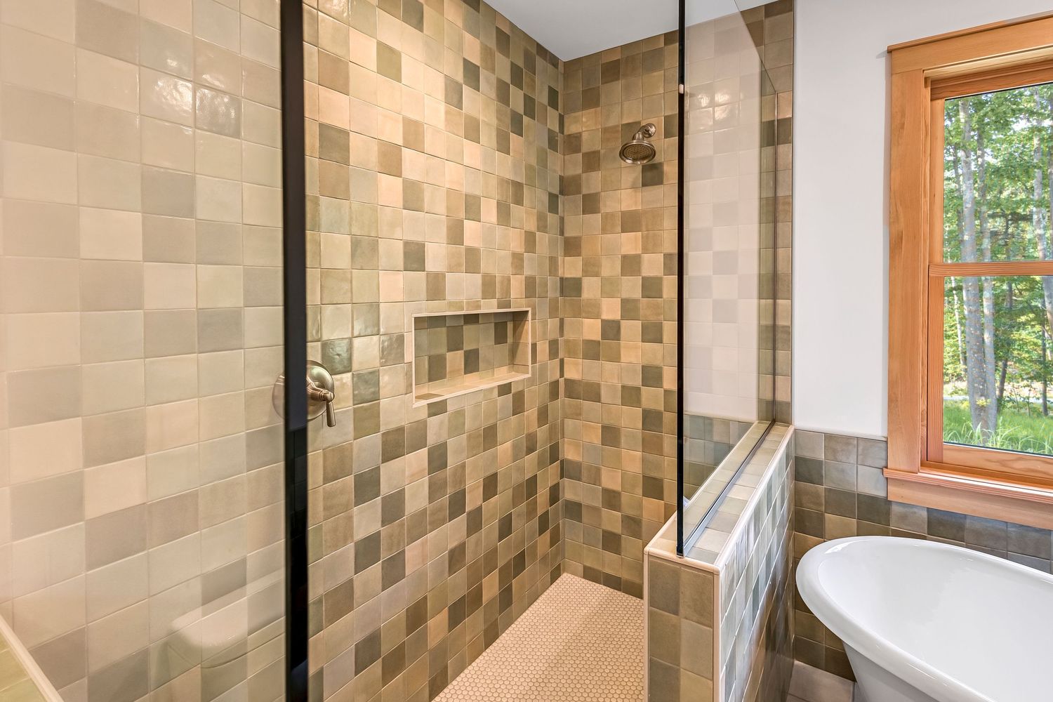 Contemporary bathroom featuring a stylish tiled shower enclosure with beige checkered pattern and window view.