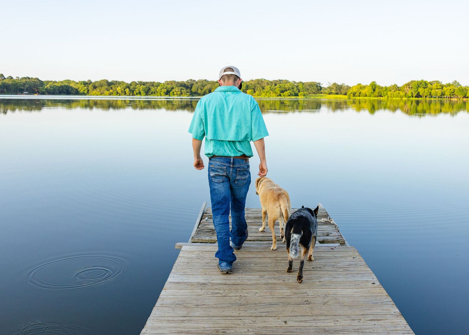 photo of boy for his small business with his dogs at a lake in east texas