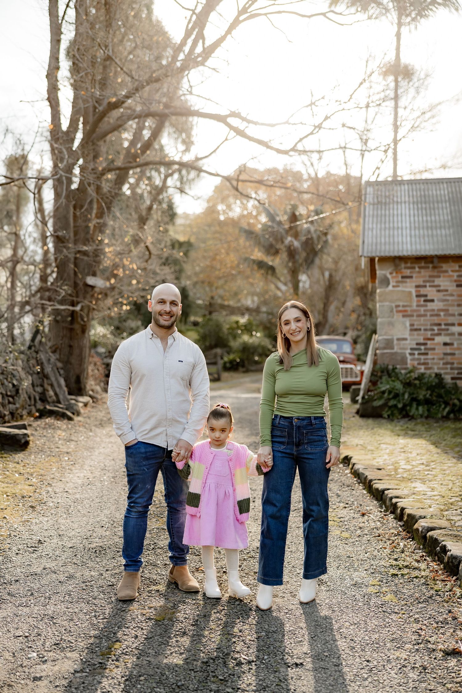 A family walks together on a gravel path, with three different perspectives showing joyful moments in casual attire.