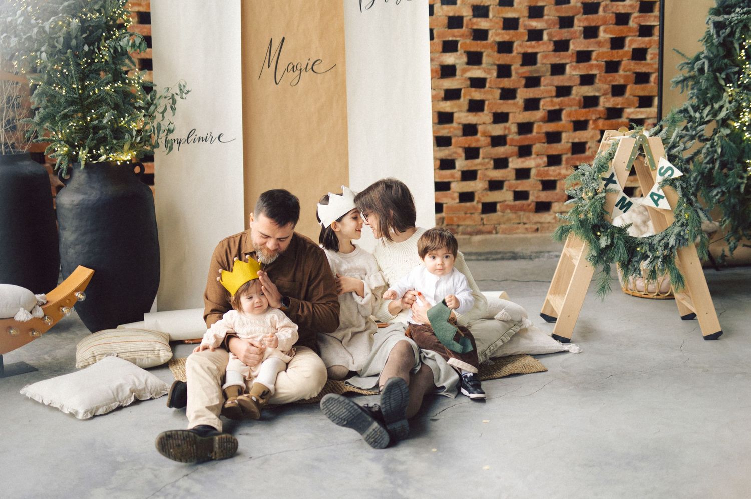 A relaxed scene with people sitting on floor cushions against a modern wall with decorative planters and greenery.