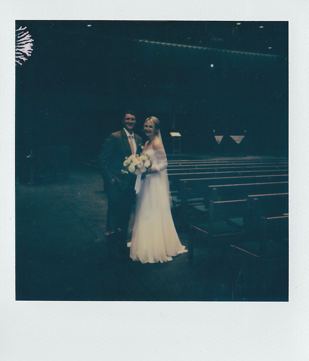 Elegant wedding couple photographed in dramatic lighting on their special day.