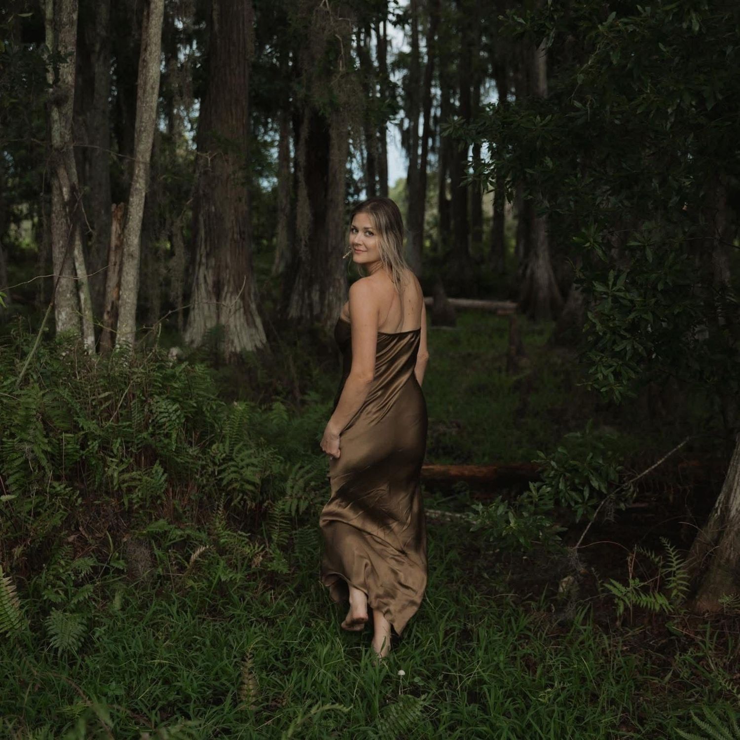 A series of artistic forest photographs showing a figure in a brown dress moving through a mystical woodland setting.