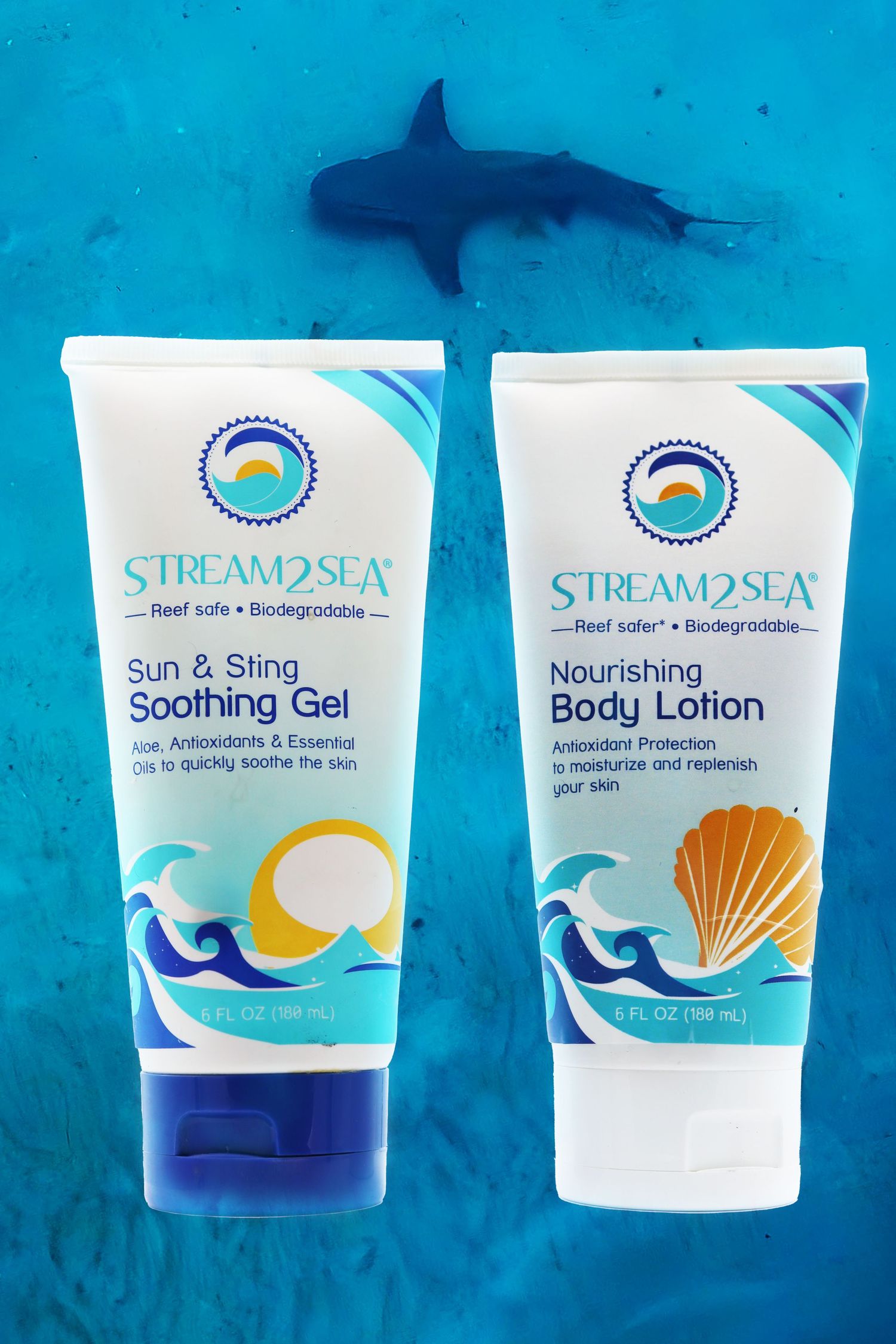 Stream2Sea reef-safe sunscreen and body lotion products displayed on turquoise background with shark silhouette.