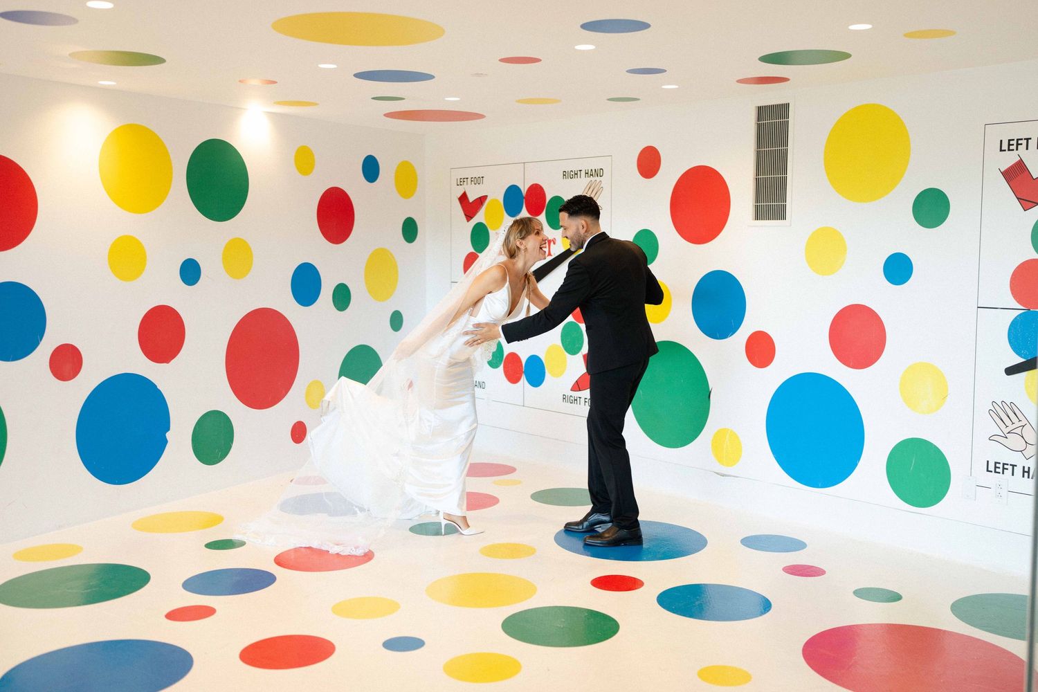 A colorful polka dot room features brightly colored circular patterns on white walls and floor.
