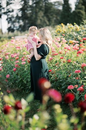A peaceful garden scene with vibrant pink zinnias and yellow sunflowers creating a colorful natural backdrop.