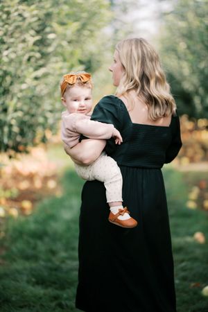 A touching moment captured in an apple orchard on a bright autumn day.