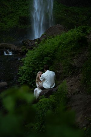 Couple embracing at latourell falls in an oregon elopement photoshoot