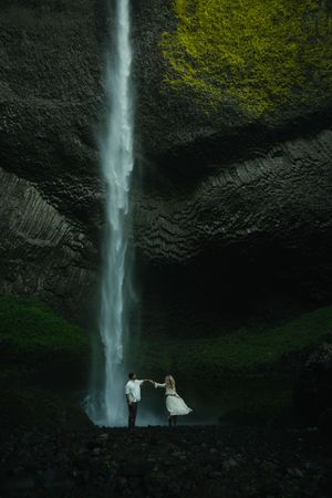 Couple dancing at the bottom of Latourell Falls during an Oregon engagement photoshoot