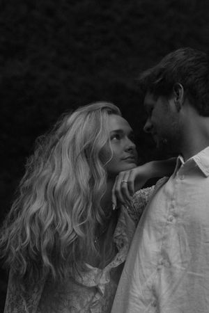 Couple looking into each other's eyes with the Latourell Falls behind them at an Oregon engagement photoshoot