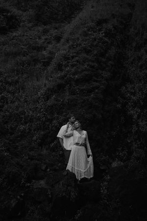 Couple hugging at latourell falls in an oregon elopement photoshoot