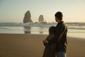 Couple enjoying the view of Canon beach in Oregon at sunset for their engagement photoshoot