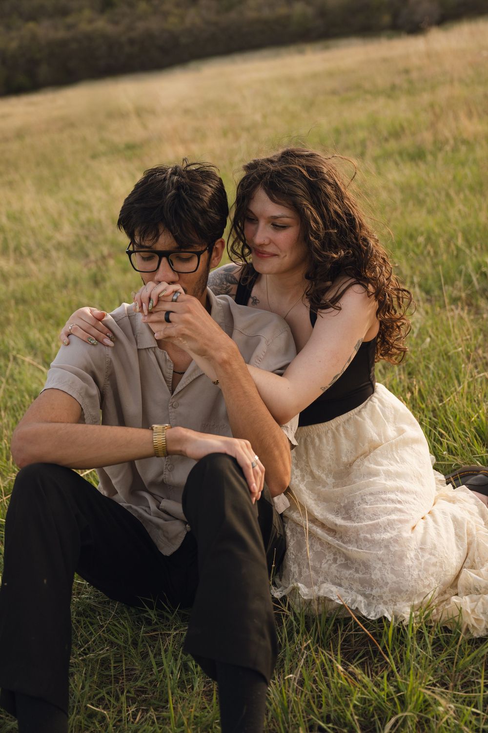 couples sitting on the grass for an engagement photoshoot in northern utah