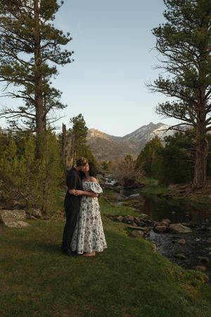 Lesbian couple sharing a quiet moment in the Utah mountains at sunset engagement session