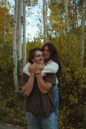 Autumn engagement session on Cedar Mountain in Utah with golden fall foliage hugging