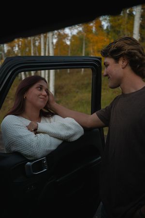 Autumn engagement session in the Utah mountains with golden fall foliage in a jeep
