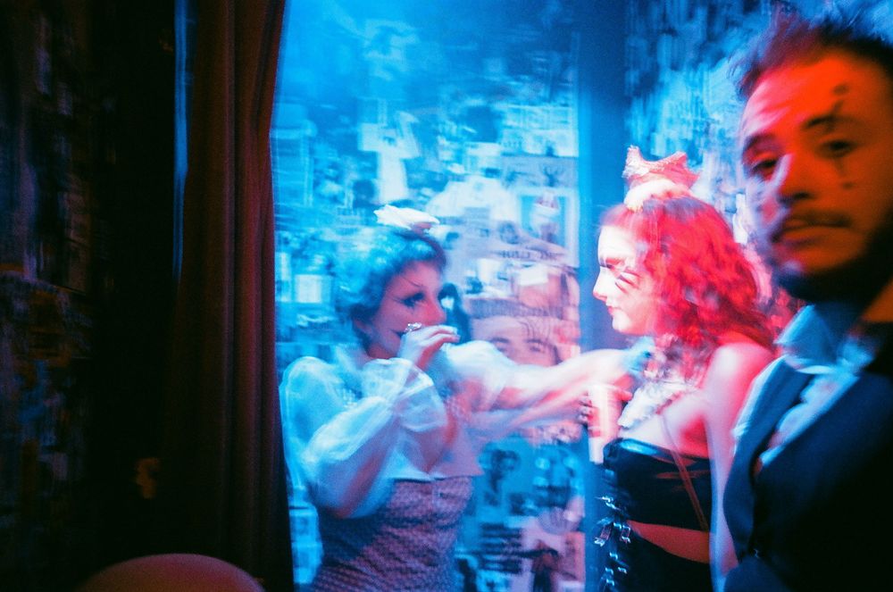 Dance party scene with blue lighting and motion blur effects.