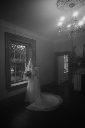 Bride holding her flowers with veil over her face at The Bentley House in St. George, Utah