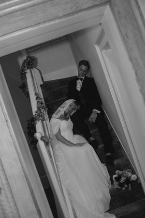 Bride and groom posing on the stairs at The Bentley House in St. George, Utah