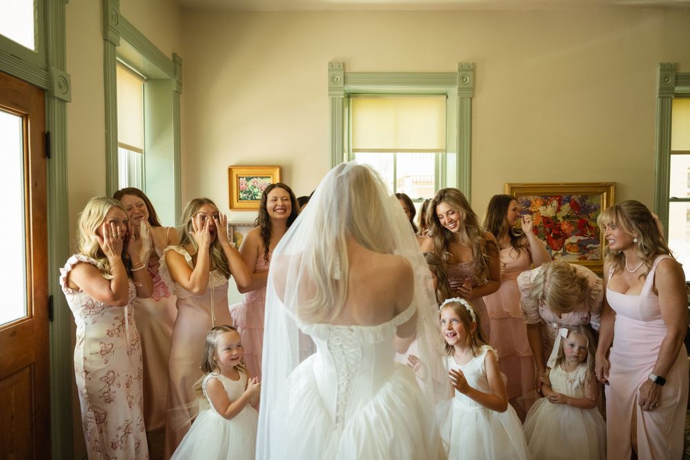 bride does her emotional first look with her bridesmaids at her wedding day in northern utah