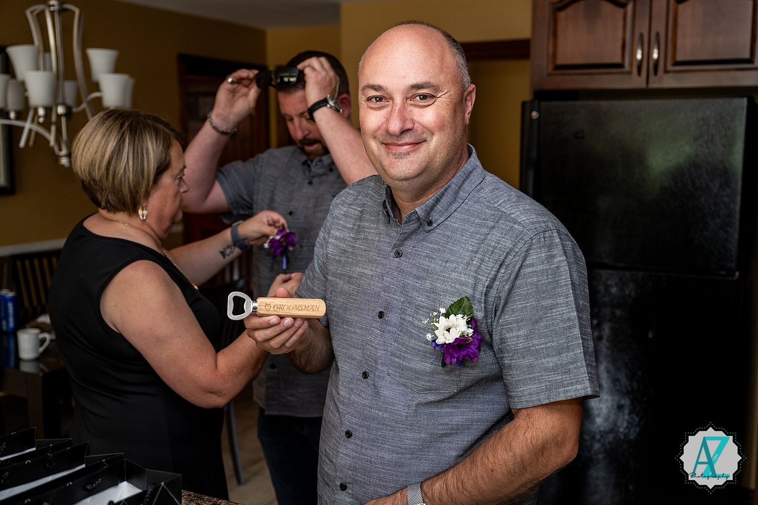 Wedding guests socialize and enjoy drinks at an indoor reception venue.
