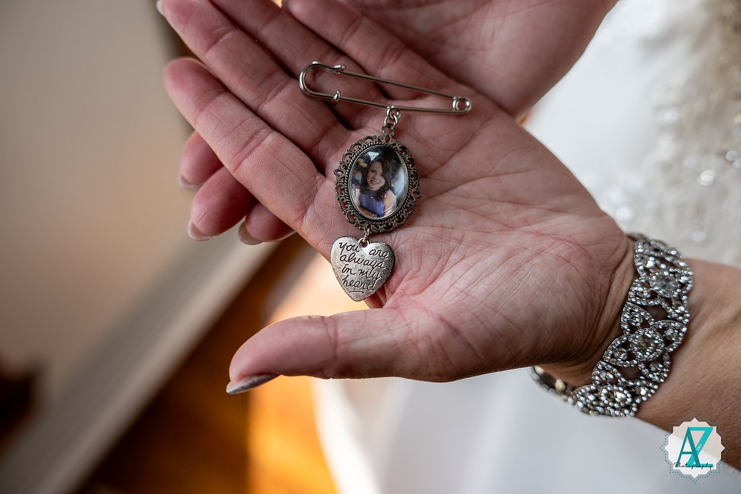 Close-up details of wedding rings and jewelry being displayed on hands with elegant manicures.