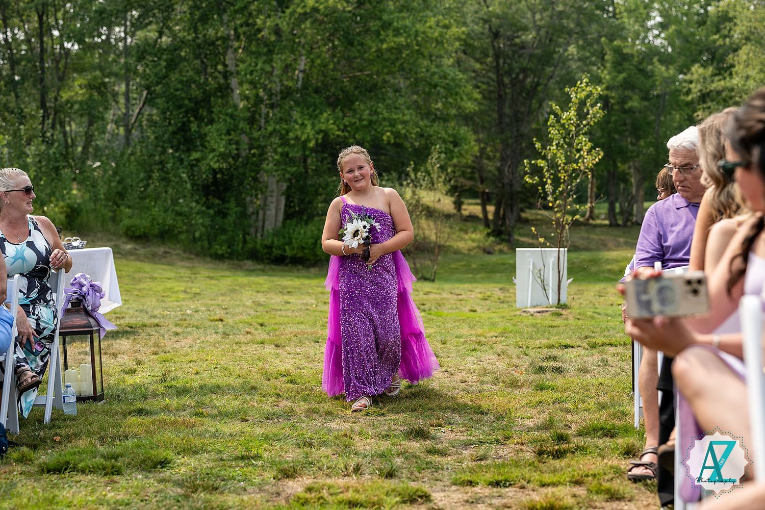 A summer outdoor gathering at a verdant park features a group wearing colorful attire enjoying festivities together.