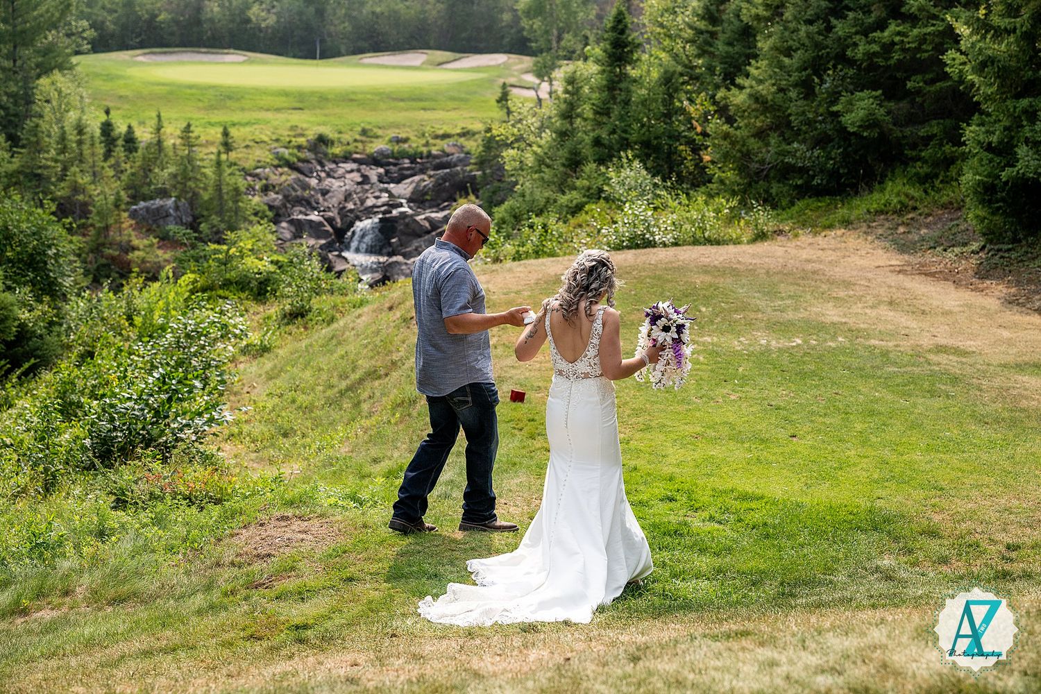 Wedding ceremony surrounded by scenic green mountain landscape on a sunny summer day.