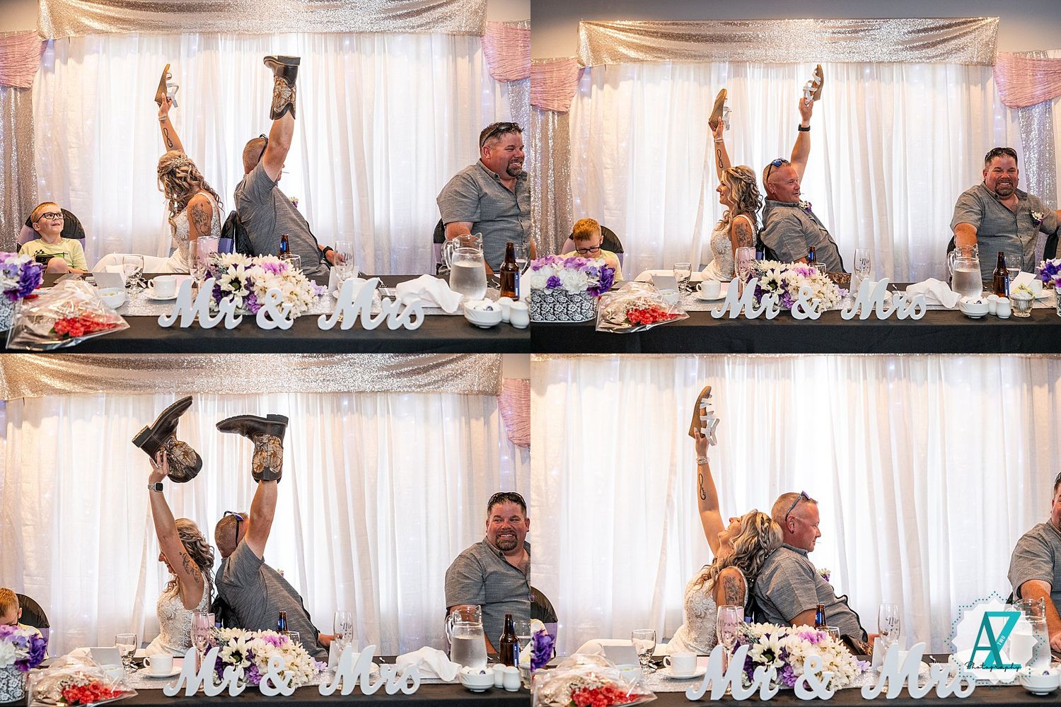 Wedding party guests cheering and raising drinks at a decorated reception head table during celebration.
