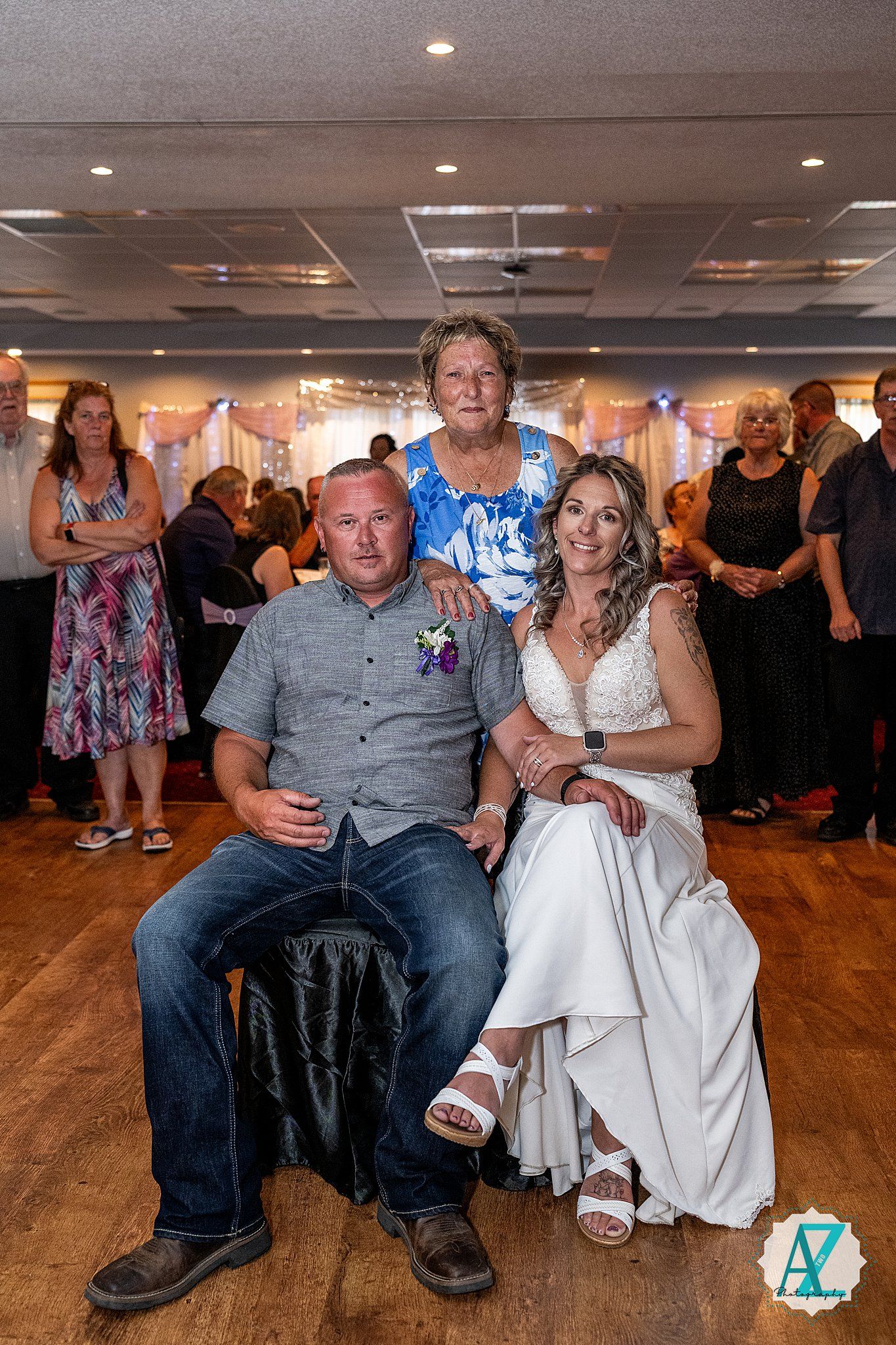 A couple sits together during a dance reception showing various candid moments on a wooden dance floor.