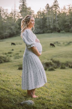 Mother standing in an idyllic field during their family and maternity photoshoot at Whidbey Island near Seattle, Washington