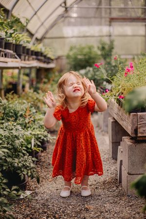 Mother and children hugging and sitting together during their greenhouse motherhood photoshoot at Christianson Nursery near Seattle WA