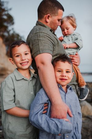 Dad and children together during their family photo session in Deception Pass near Seattle Washington