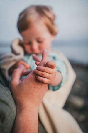 Child and dad together during their family photo session in Deception Pass near Seattle Washington