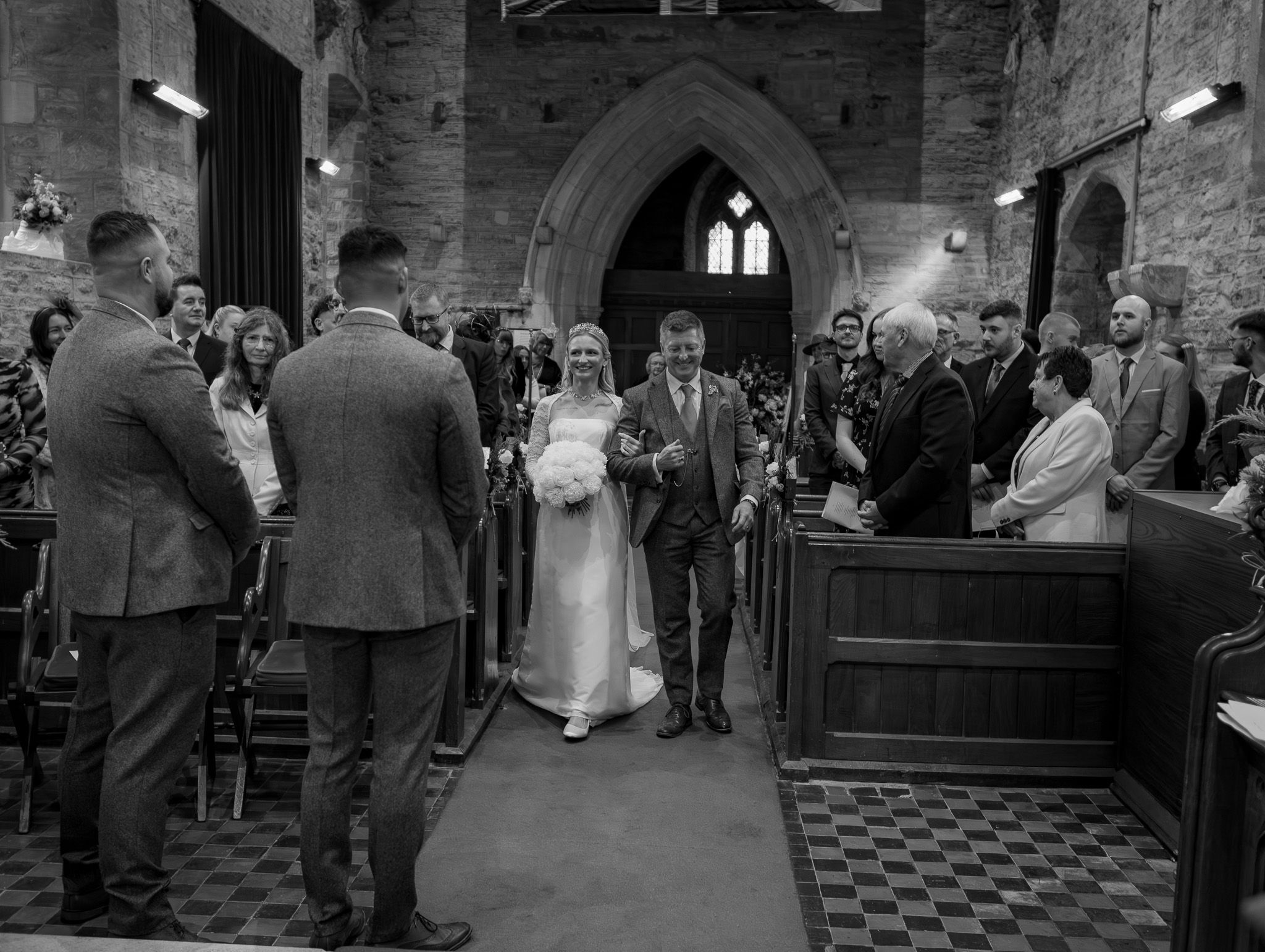 A collection of black and white wedding photos showing guests and ceremonies in a historic stone church interior.