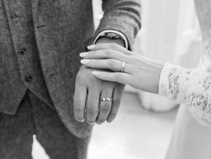 Close-up view of hands exchanging wedding rings during a romantic ceremony.