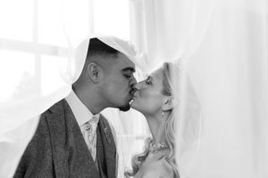 A romantic black and white photo montage shows couples kissing in elegant formal attire.