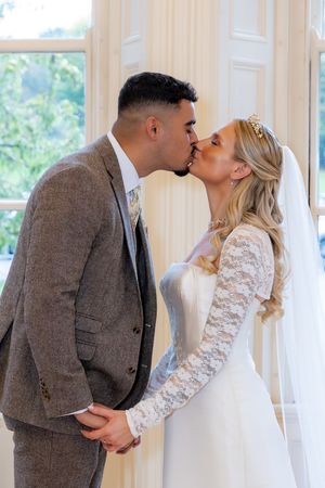 A romantic series of wedding photos showing a couple kissing in a sunlit room with white curtains.