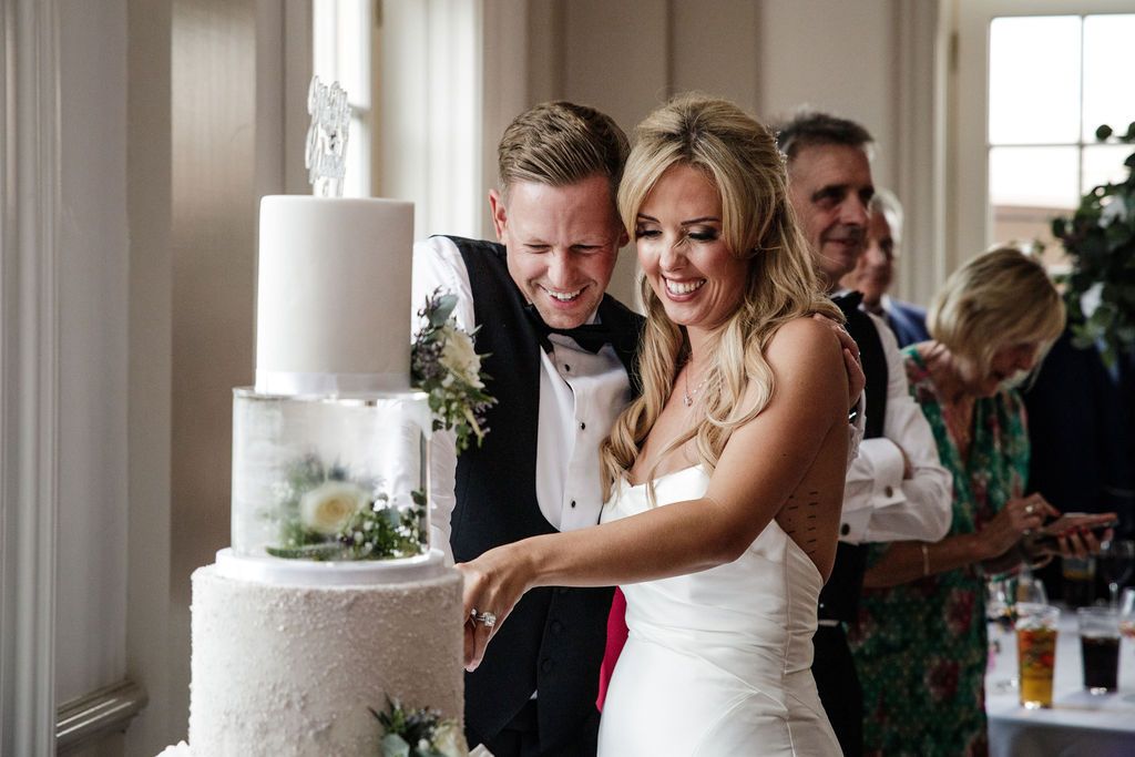 Bride and Groom sitting their cake