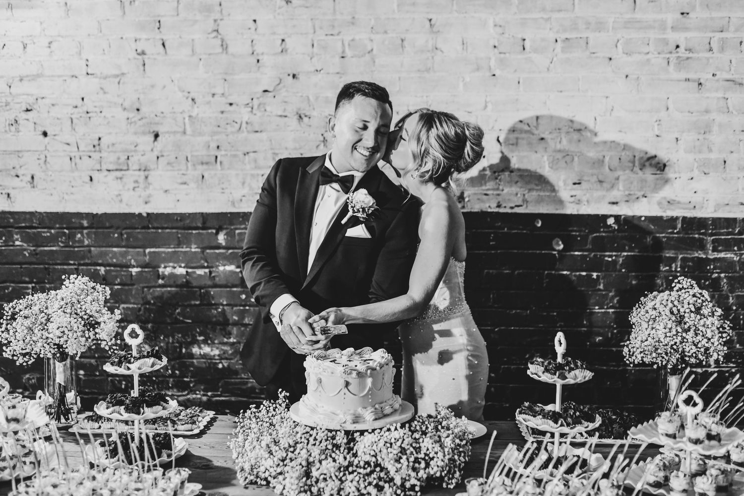 Bride and groom cut their wedding cake with modern direct flash at Brake and Clutch Warehouse