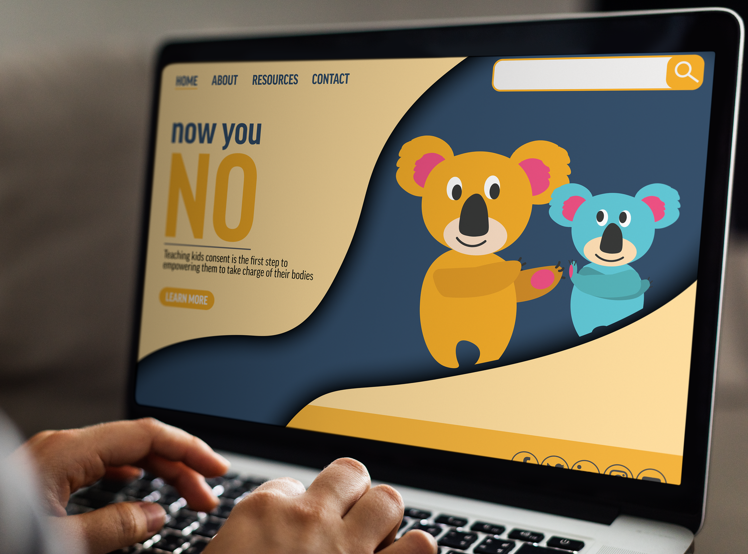 Laptop screen showing colorful cartoon koala characters in a website design project.