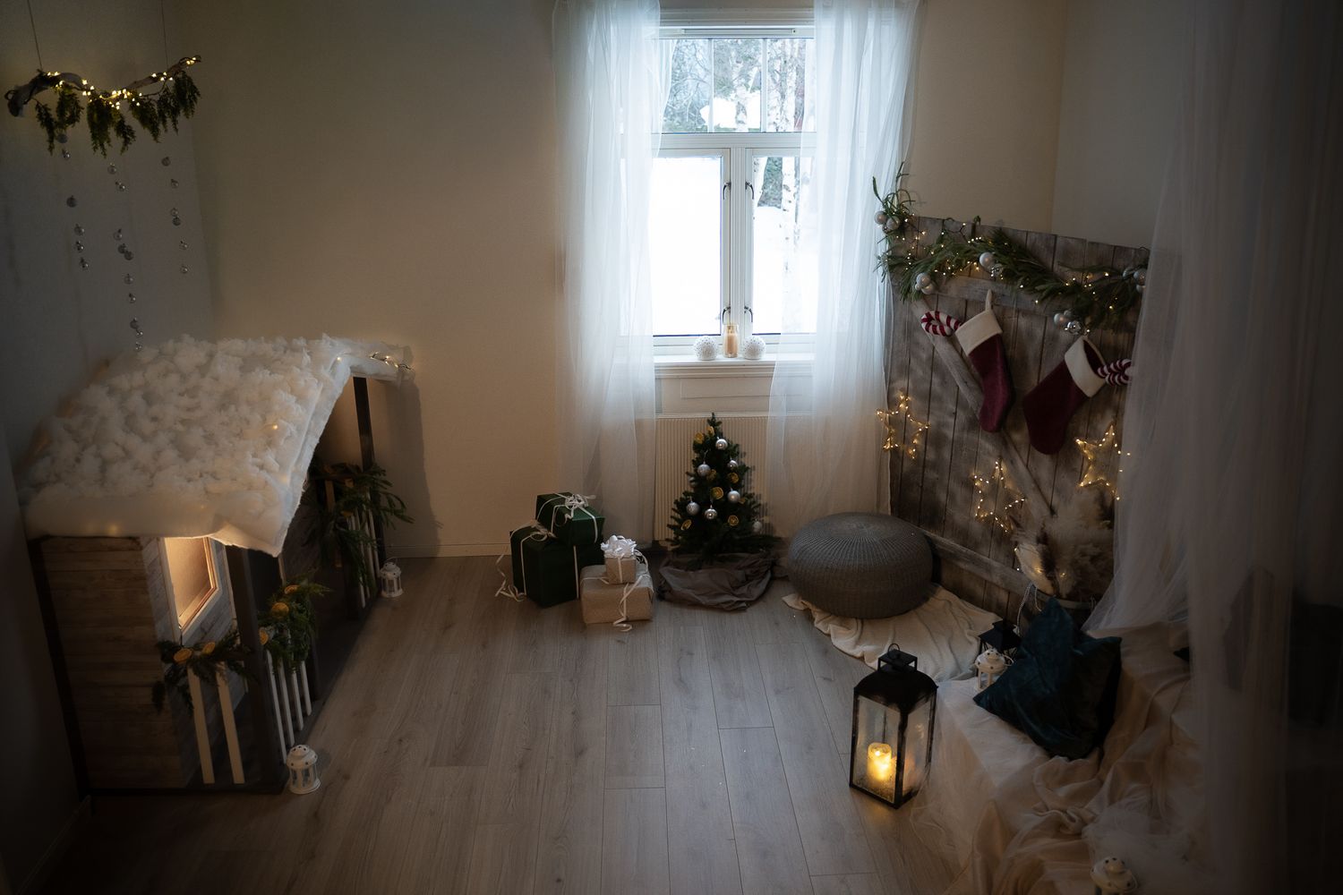 A cozy bedroom corner with white curtains, potted plants, and a warm glowing lantern creating a peaceful atmosphere.