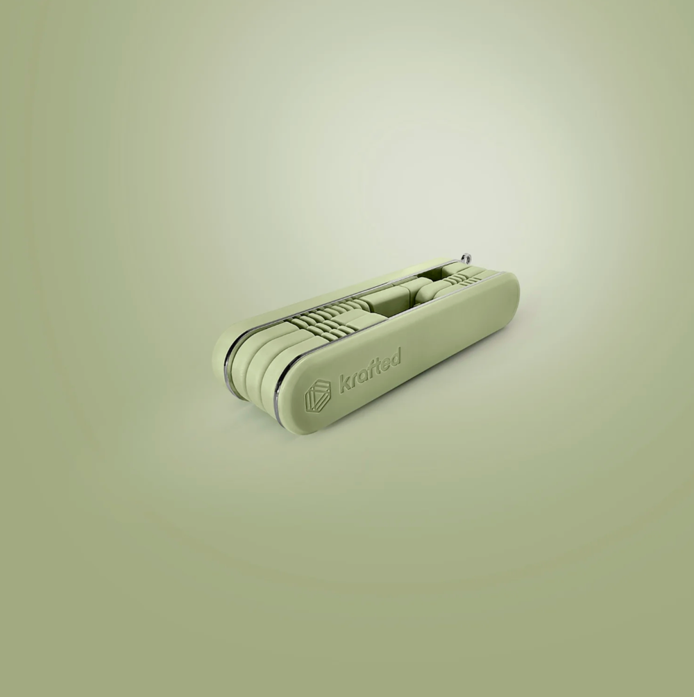 Close-up view of a sleek white USB device against a light green background.