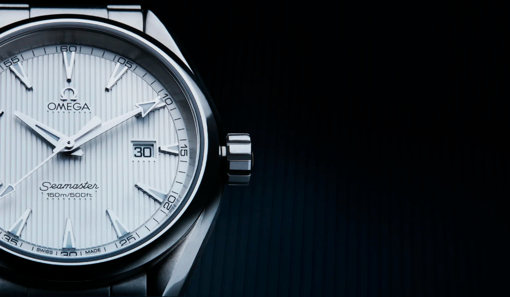 Close-up of elegant white dial luxury watch face with silver details.