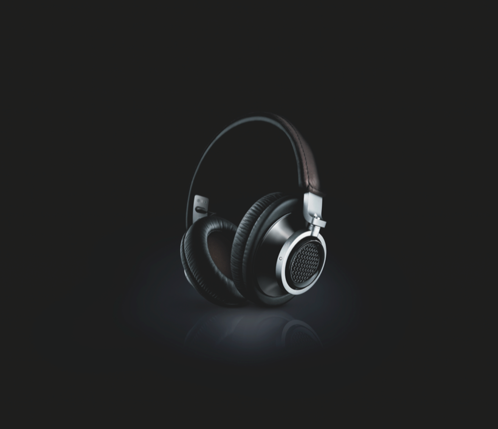 Dramatic black and white product shots of sleek wireless headphones in dark lighting.